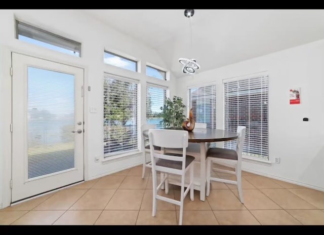 tiled dining room with vaulted ceiling