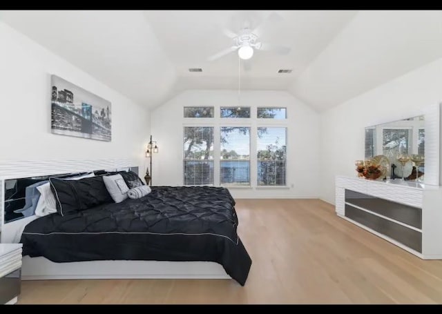 bedroom featuring ceiling fan, hardwood / wood-style flooring, and lofted ceiling