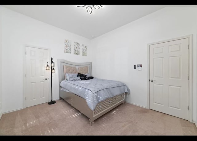 bedroom with light carpet