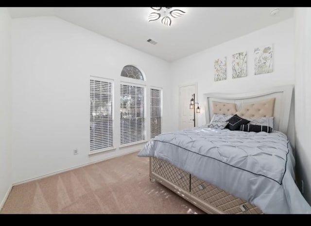 bedroom featuring vaulted ceiling and carpet flooring