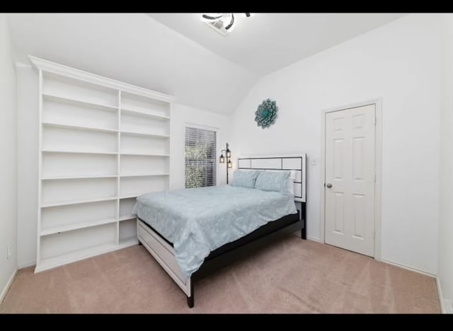 carpeted bedroom with vaulted ceiling