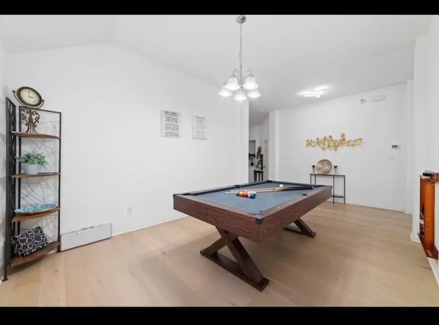 playroom with pool table, an inviting chandelier, light wood-type flooring, and vaulted ceiling