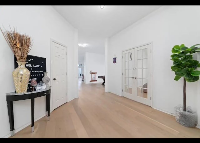 corridor with hardwood / wood-style flooring