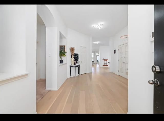 hallway with light hardwood / wood-style flooring