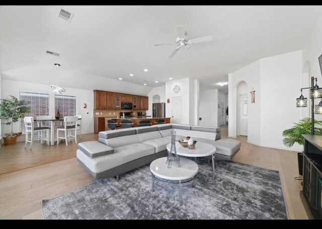 living room featuring light wood-type flooring and ceiling fan