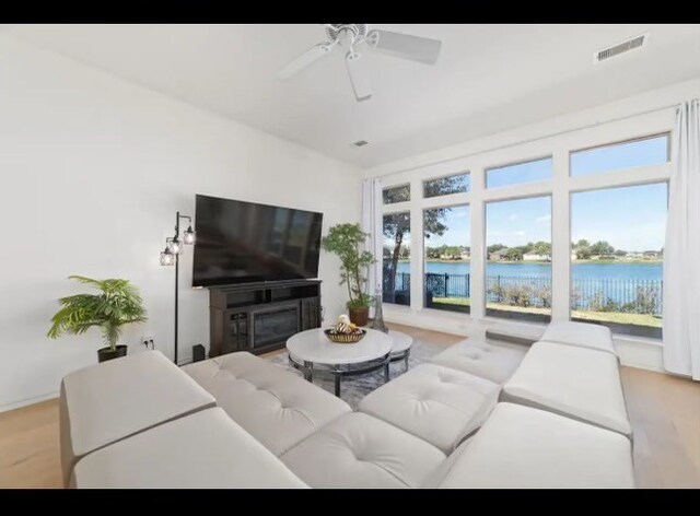 living room featuring light hardwood / wood-style floors and ceiling fan