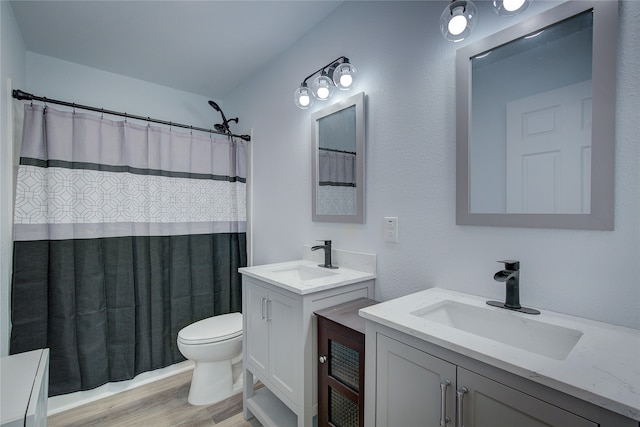 bathroom featuring vanity, walk in shower, hardwood / wood-style flooring, and toilet