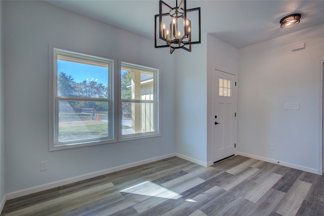 foyer with wood-type flooring and a chandelier