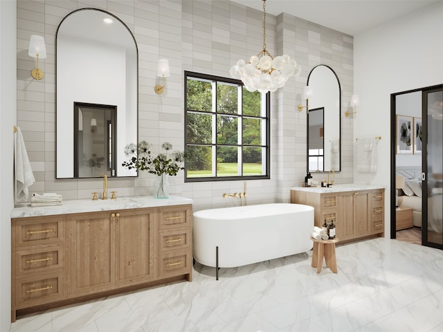 bathroom featuring a bathing tub, vanity, tile walls, and an inviting chandelier