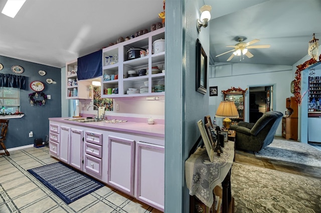 kitchen featuring vaulted ceiling, sink, and ceiling fan