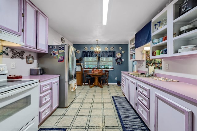 kitchen featuring stainless steel refrigerator, decorative light fixtures, sink, a chandelier, and electric stove