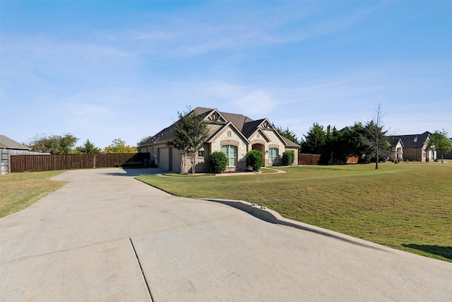 view of front of home with a garage and a front lawn