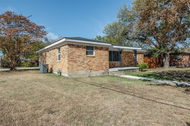 view of home's exterior with a yard and central air condition unit