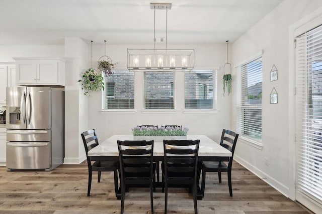 dining room featuring dark wood-type flooring and baseboards