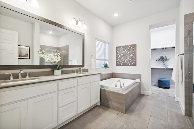 bathroom featuring vanity, plus walk in shower, and tile patterned flooring