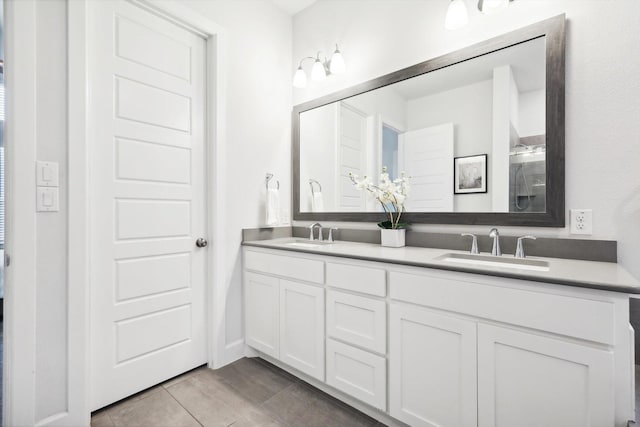 bathroom featuring double vanity and a sink