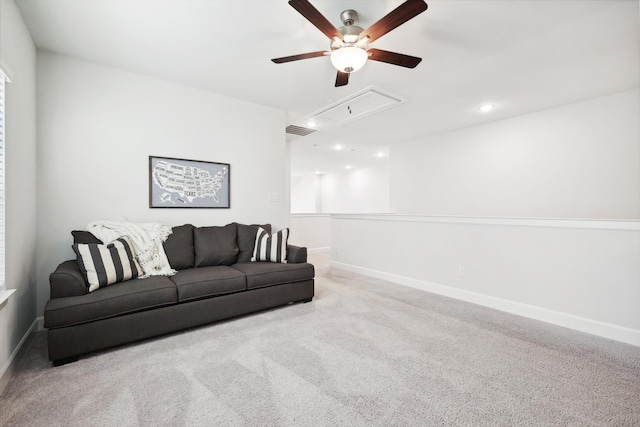 carpeted living room with ceiling fan