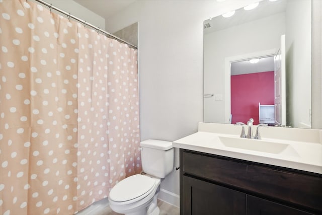 bathroom featuring vanity, toilet, and a shower with curtain