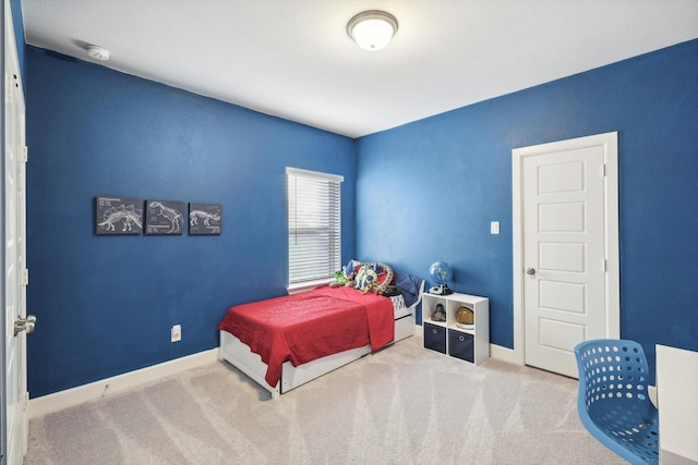 bedroom with carpet floors and baseboards