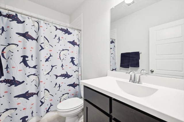 bathroom featuring vanity, curtained shower, and toilet