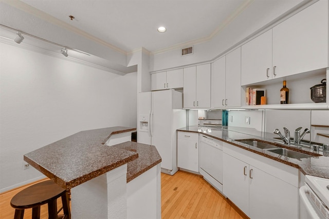 kitchen with ornamental molding, white cabinets, white appliances, and light hardwood / wood-style floors