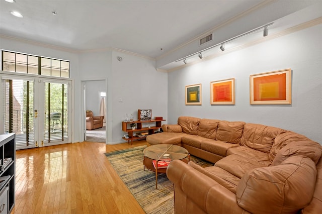 living room with ornamental molding, hardwood / wood-style flooring, and rail lighting