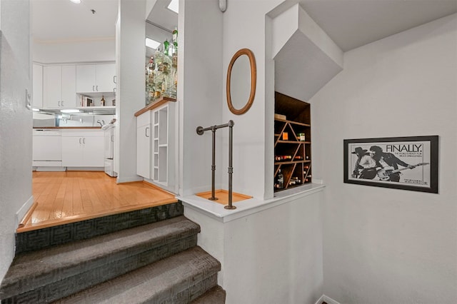 stairs featuring hardwood / wood-style floors