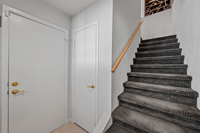 stairway featuring tile patterned flooring