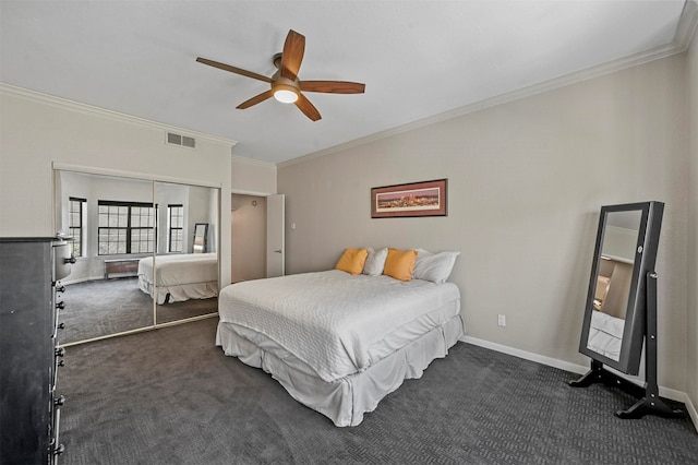 carpeted bedroom featuring a closet, ceiling fan, and ornamental molding