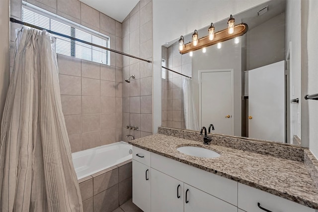 bathroom featuring vanity and shower / bath combo