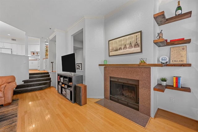 living room with crown molding and hardwood / wood-style flooring