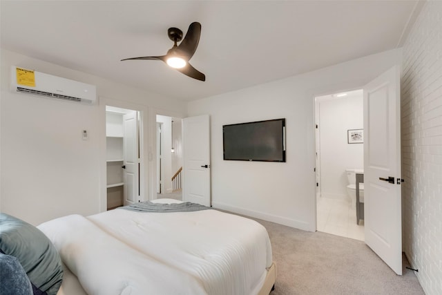 4039 Cole Ave Unit 119, Dallas, TX 75204 - bedroom with connected bathroom, a walk in closet, ceiling fan, light carpet, and an AC wall unit
