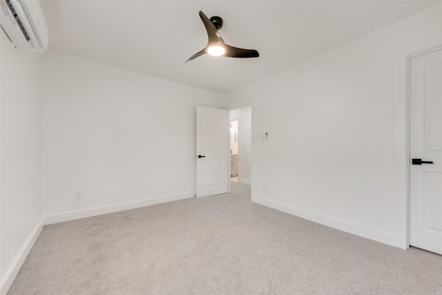 4039 Cole Ave Unit 119, Dallas, TX 75204 - empty room featuring carpet flooring, baseboards, a ceiling fan, and an AC wall unit