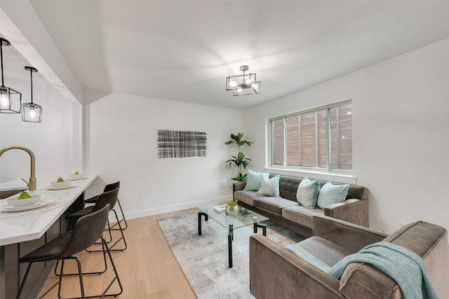 living room featuring light hardwood / wood-style floors and a notable chandelier