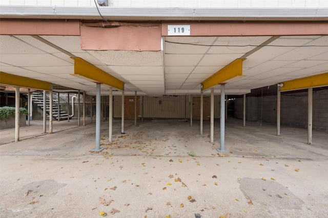 4039 Cole Ave Unit 119, Dallas, TX 75204 - unfinished basement featuring a drop ceiling and stairway