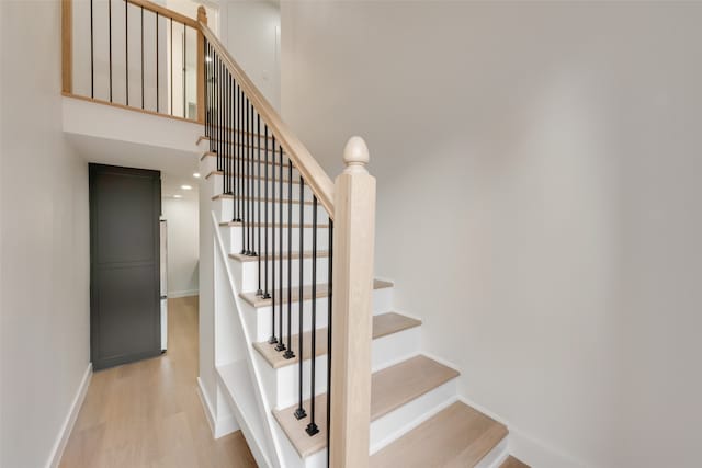 stairs with hardwood / wood-style flooring