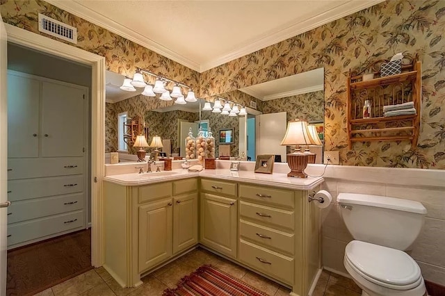 bathroom with vanity, ornamental molding, toilet, and tile patterned floors