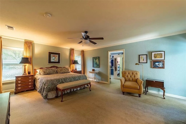 carpeted bedroom featuring a closet, ceiling fan, ornamental molding, and a walk in closet