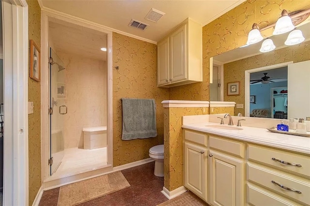 bathroom with toilet, a shower with shower door, ornamental molding, vanity, and ceiling fan