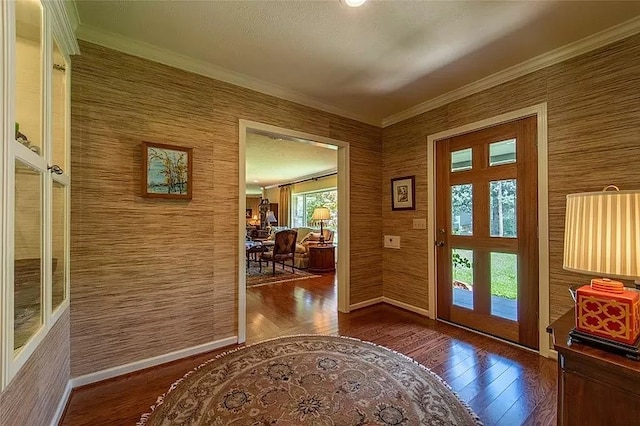 entrance foyer with crown molding, dark hardwood / wood-style floors, and french doors