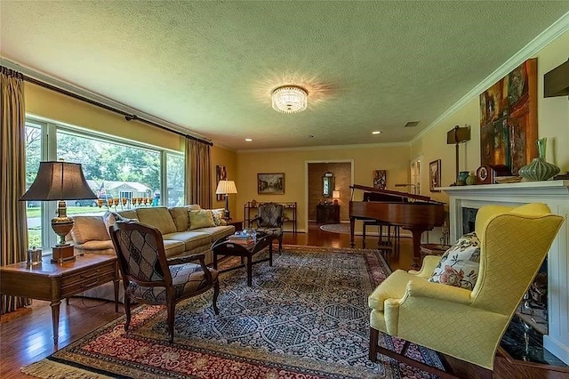 living room with crown molding, a textured ceiling, and hardwood / wood-style floors