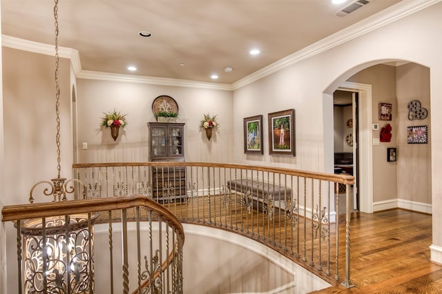 corridor featuring ornamental molding and dark hardwood / wood-style flooring