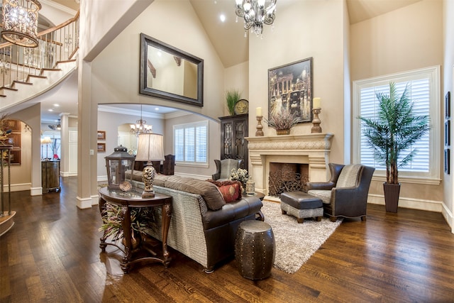 living room featuring dark hardwood / wood-style floors, plenty of natural light, high vaulted ceiling, and ornamental molding