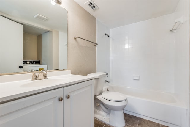 full bathroom featuring toilet, tiled shower / bath combo, vanity, and tile patterned flooring