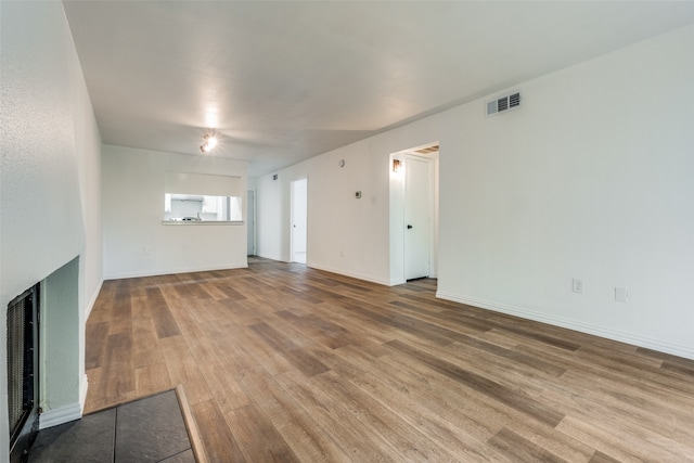 unfurnished living room featuring wood-type flooring