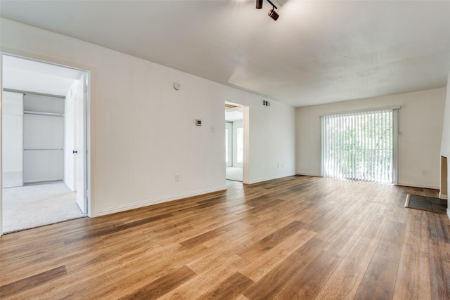 unfurnished living room with light wood-type flooring