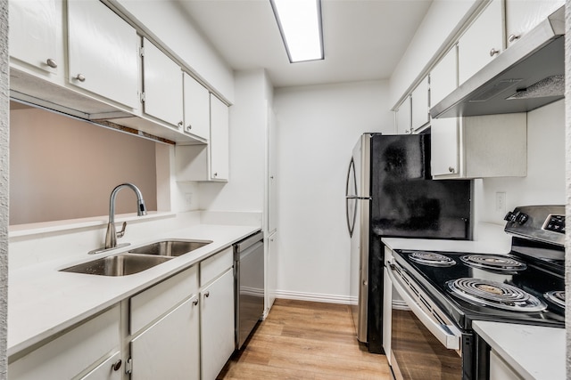 kitchen featuring light hardwood / wood-style floors, appliances with stainless steel finishes, sink, and white cabinets