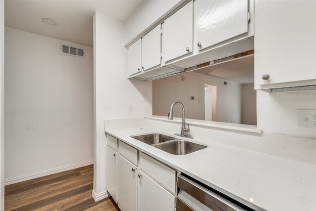 kitchen featuring white cabinets, sink, and dark wood-type flooring