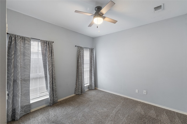 spare room with carpet and ceiling fan