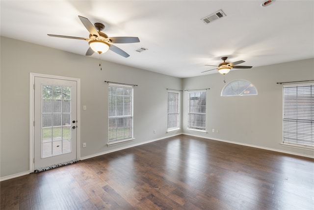 spare room with dark hardwood / wood-style floors and ceiling fan